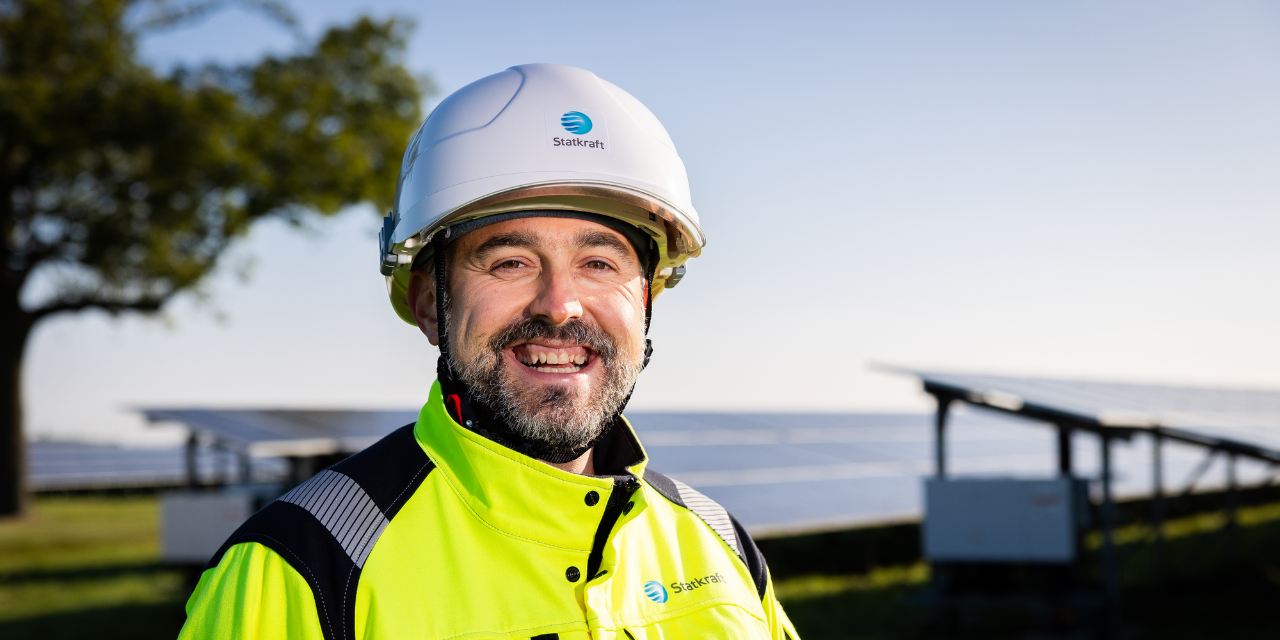 Um retrato de homem sorrindo em um parque solar